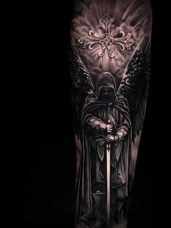 Angel tattoo against a cross